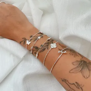 PULSEIRA MAR (CONCHA, BÚZIO E ESTRELA DO MAR). 18CM DE COMPRIMENTO E 2CM DE REGULAGEM. EM PRATA 925.