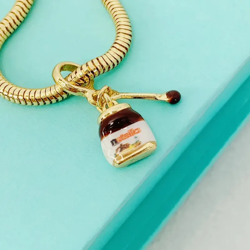 BERLOQUE NUTELLA. BANHADO A OURO 18K.