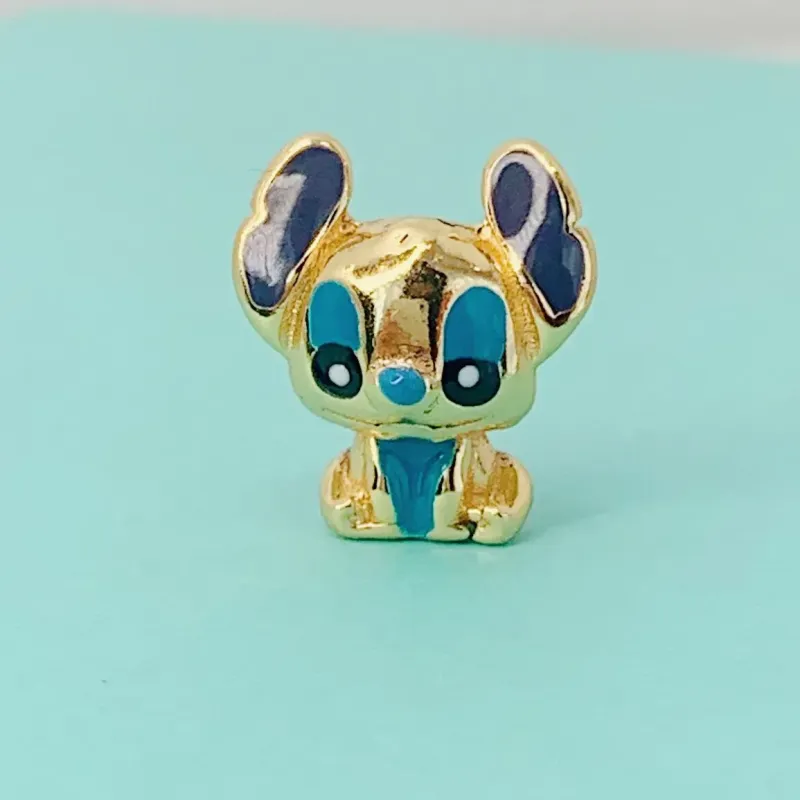 BERLOQUE STITCH. BANHADO A OURO 18K.