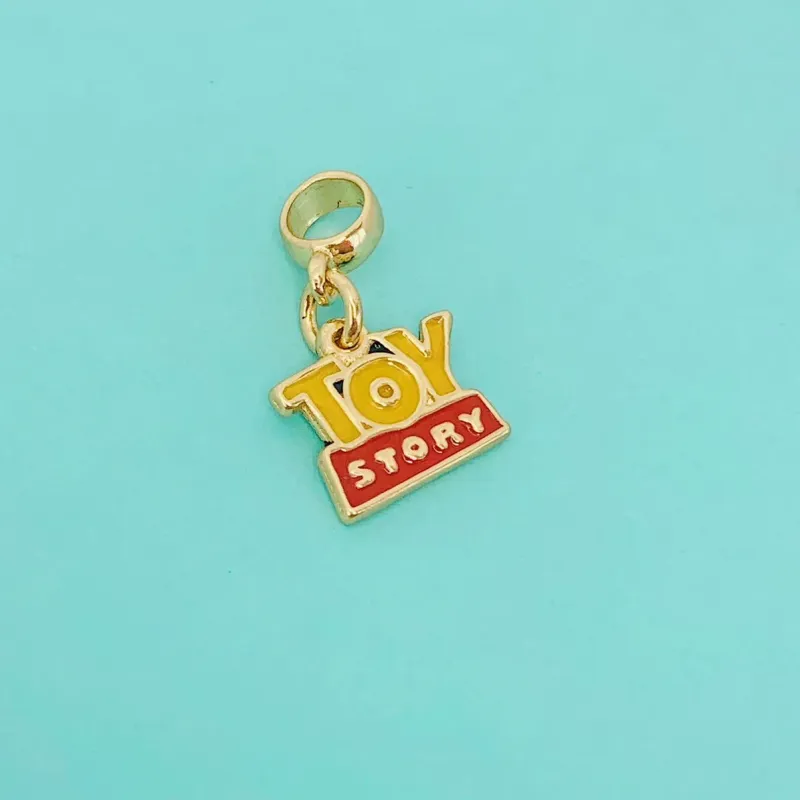 BERLOQUE TOY STORY. BANHADO A OURO 18K.