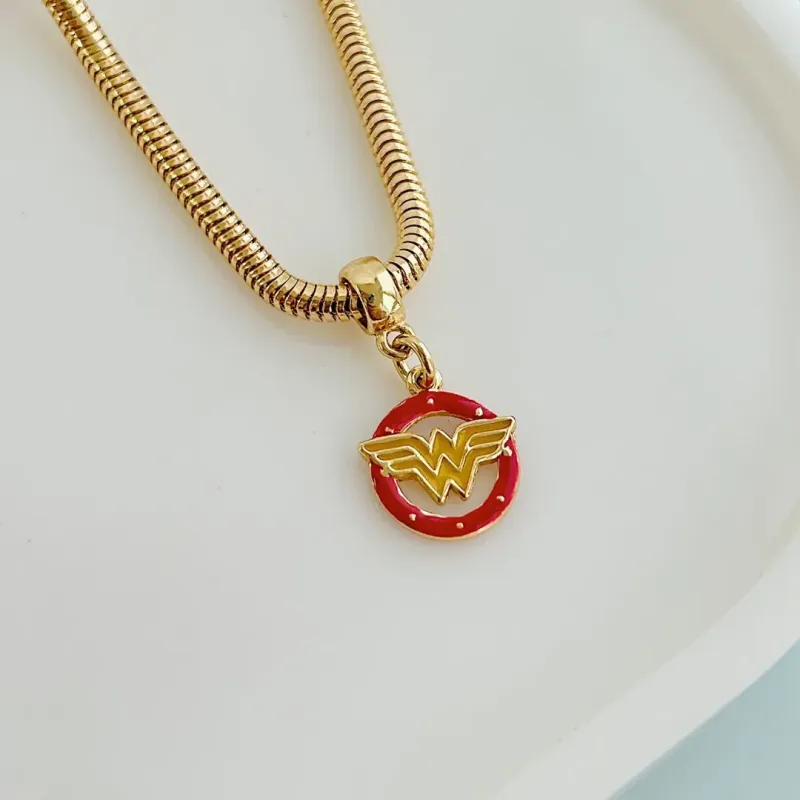 BERLOQUE SÍMBOLO MULHER MARAVILHA. BANHADO A OURO 18K.