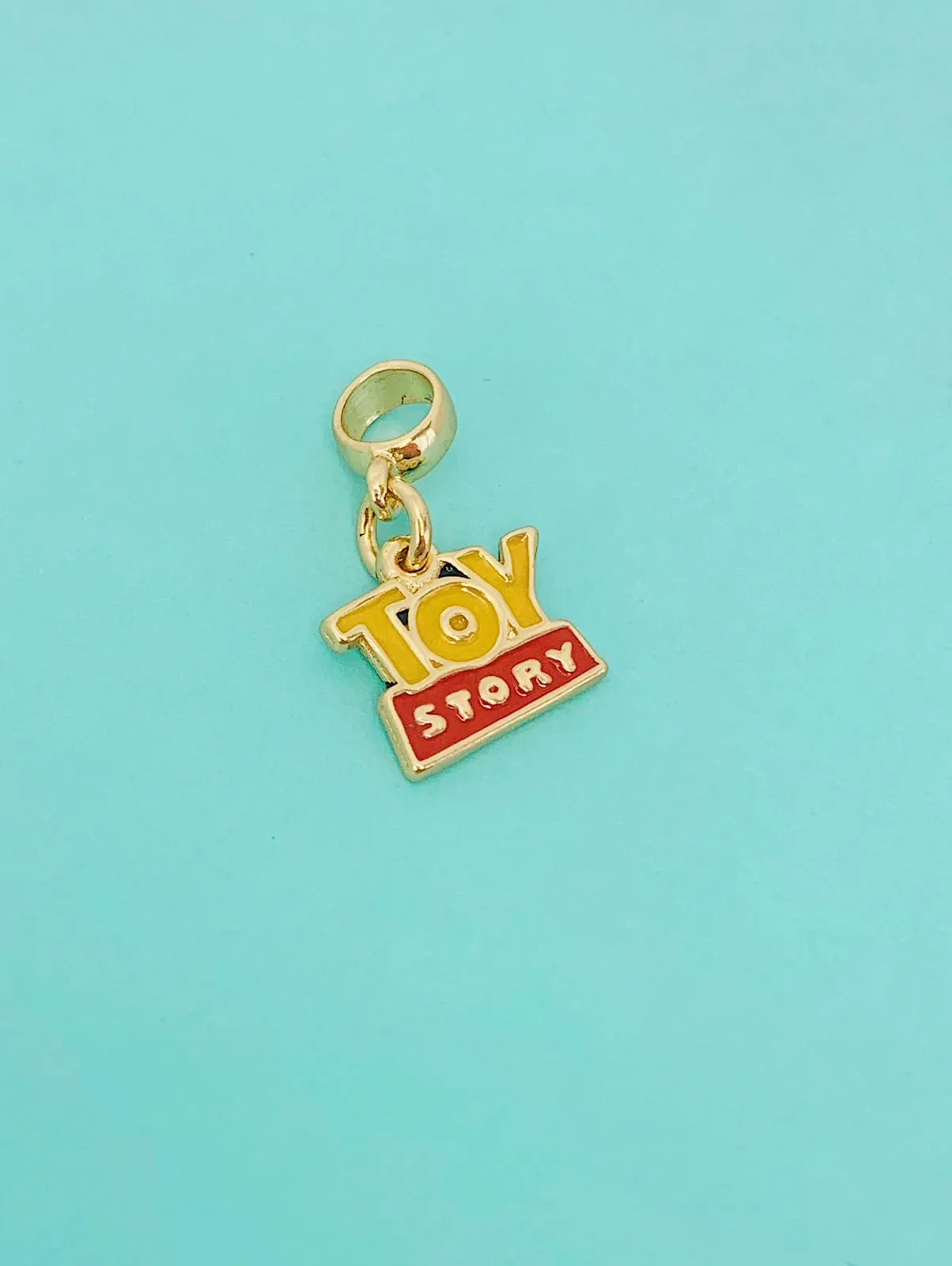 BERLOQUE TOY STORY. BANHADO A OURO 18K.