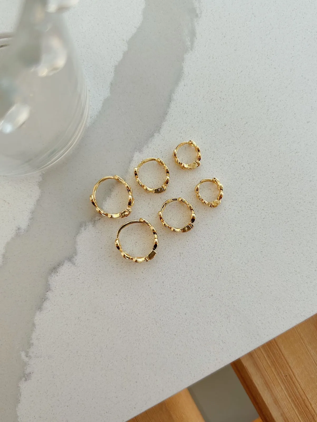 BRINCO ARGOLA COM CORAÇÕES VAZADOS. TAMANHO P. BANHADO A OURO 18K.