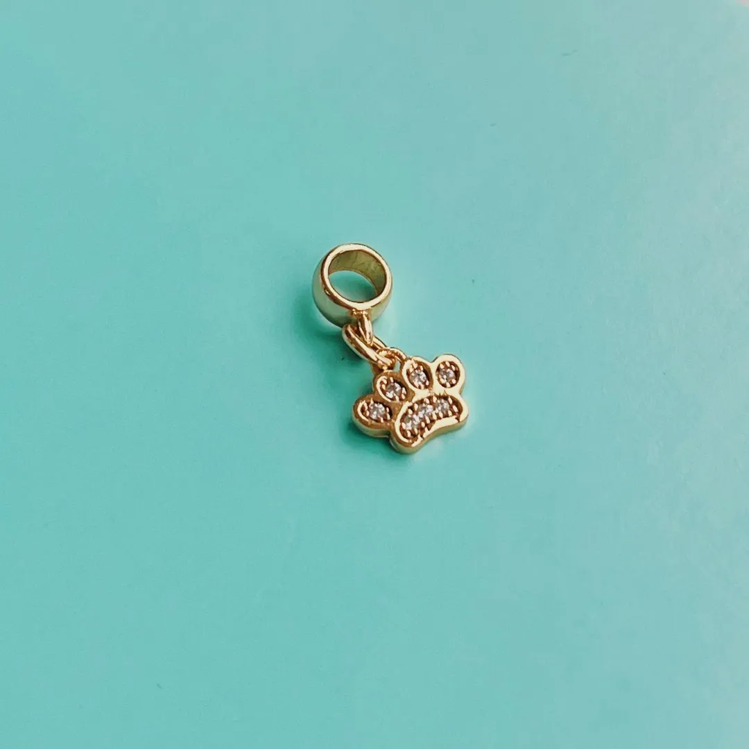 BERLOQUE PATINHA CRAVEJADA. BANHADO A OURO 18K.