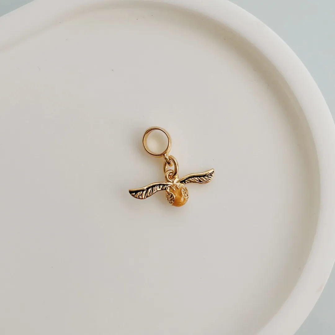 BERLOQUE POMO DE OURO (HARRY POTTER). BANHADO A OURO 18K.