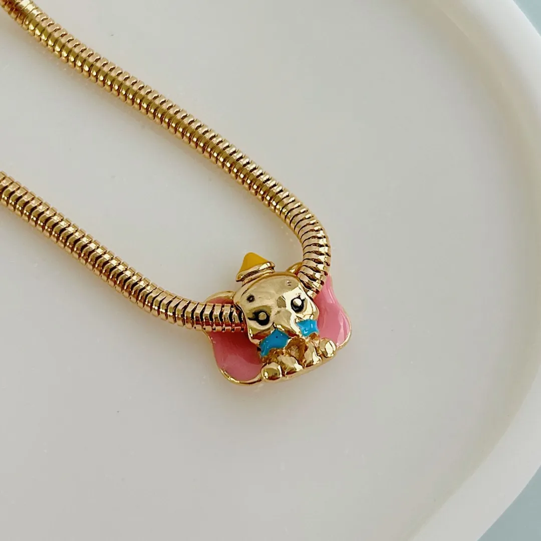 BERLOQUE SEPARADOR DUMBO. BANHADO A OURO 18K.