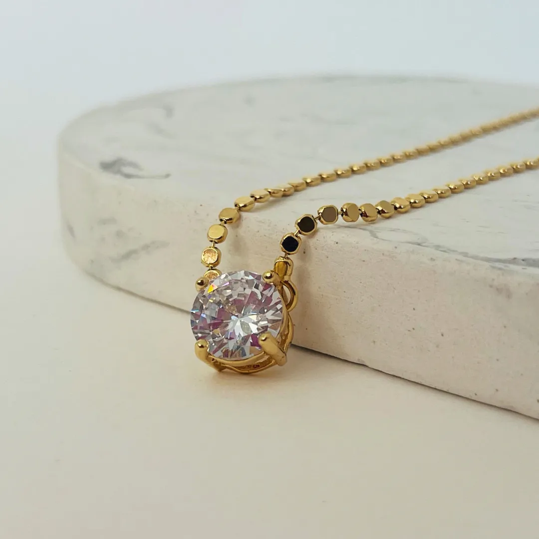 COLAR BOLINHAS ACHATADAS COM PONTO DE LUZ 10MM. 45CM DE COMPRIMENTO E 5CM DE REGULAGEM. BANHADO A OURO 18K.