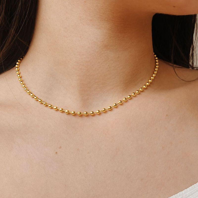 CHOKER ESFERAS 2MM. 37CM DE COMPRIMENTO E 4CM DE REGULAGEM. BANHADA A OURO